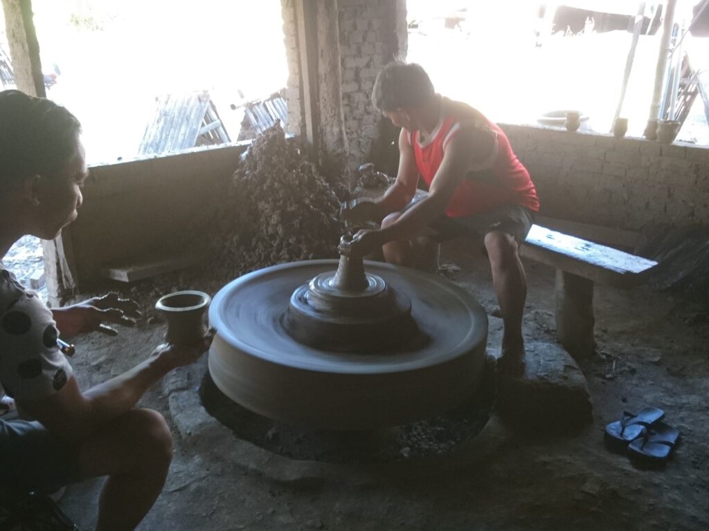 visitors making clay pot