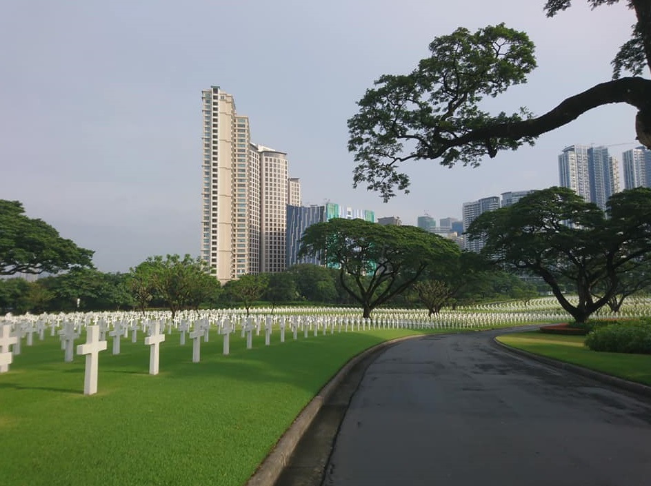thousands of white crosses lined up inside the Manila American Cemetery